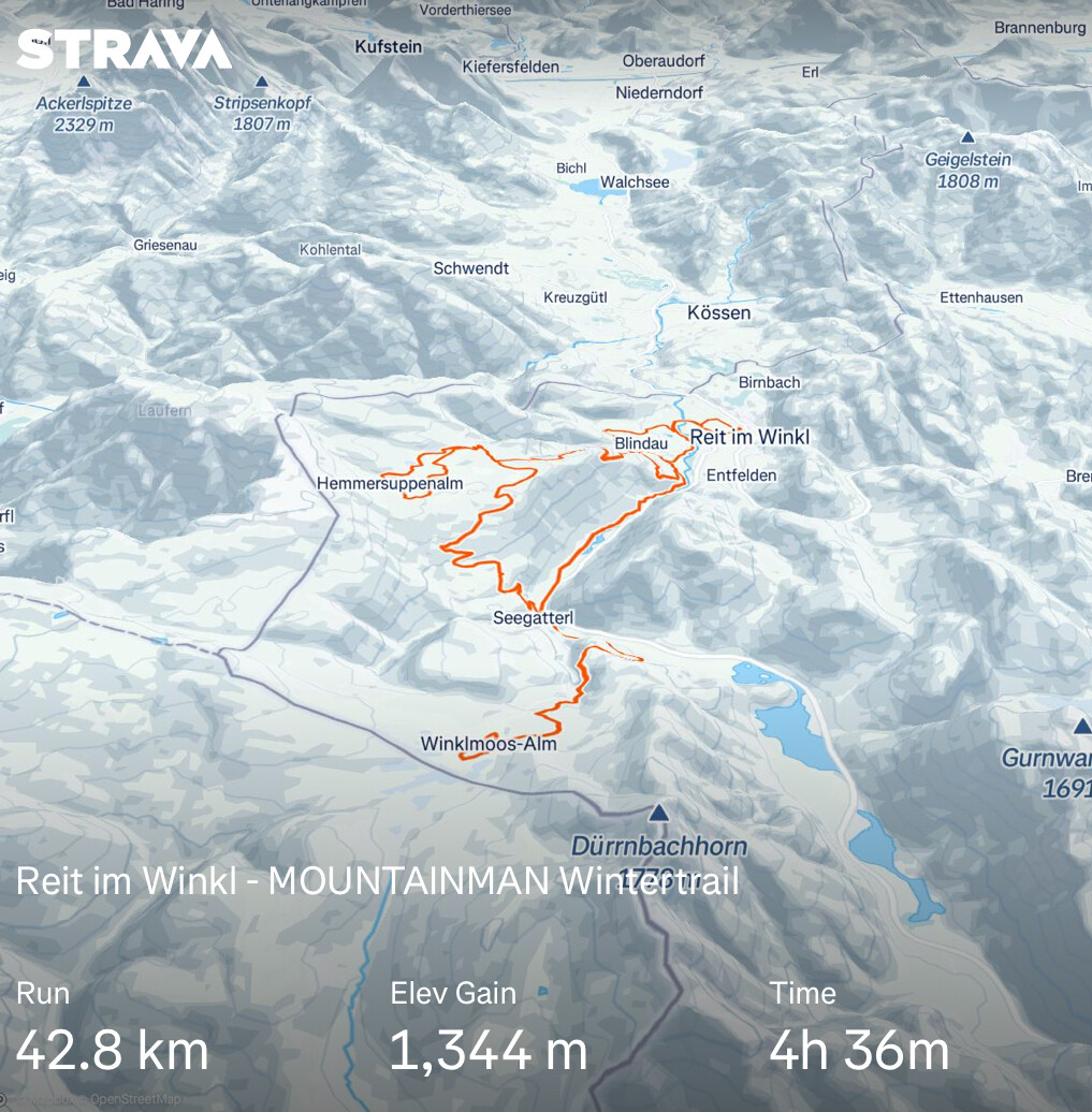 The image is a detailed map showing a trail route in a mountainous region, specifically the "Reit im Winkl - MOUNTAINMAN Wintzertrail." The map is overlaid with a bright orange line that traces the path of the trail, starting from Reit im Winkl and ending at Winklmoos-Aim. The trail covers a distance of 42.8 kilometers and has an elevation gain of 1,344 meters, completed in 4 hours and 36 minutes.

The map features a topographical representation of the area, with various peaks and valleys depicted in shades of gray and white, indicating snow-covered terrain. Notable landmarks include Ackerispitze at 2,329 meters, Stripsenkopf at 1,807 meters, and Geigelstein at 1,808 meters. The trail passes through several towns and areas, such as Hemmerssuppenalm, Blindau, and Seegattert.

The map is sourced from OpenStreetMap and includes the Strava logo in the top left corner, indicating that the trail data was likely recorded using a Strava activity. The text at the bottom of the image provides key statistics about the run, including distance, elevation gain, and time.

Provided by @altbot, generated privately and locally using Ovis2-8B

🌱 Energy used: 0.271 Wh